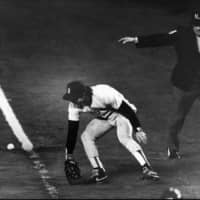 Red Sox first baseman Bill Buckner mishandles a ground ball in the 10th inning in Game 6 of the 1986 World Series. The Mets triumphed and also won the decisive seventh game.