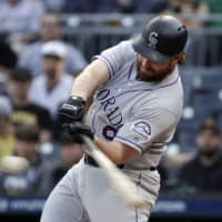 Colorado's Daniel Murphy connects for a three-run home run against Pittsburgh in the first inning on Wednesday night.
