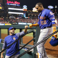 The Mets' Yoenis Cespedes is congratulated by manager Mickey Callaway after hitting a three-run home run on April 24, 2018.