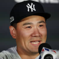 Yankees pitcher Masahiro Tanaka speaks to the media at a news conference in London on Friday.