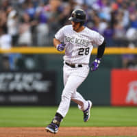 Colorado's Nolan Arenado runs the bases after hitting a two-run homer against Los Angeles in the first inning on Friday night.