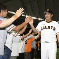 Giants ace Tomoyuki Sugano greets fans after beating the Marines in his return from injury on Sunday at Tokyo Dome.