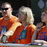 From left: Chris, Lisa and Ariana Kukec watch the Oakland Athletics during batting practice on Monday at Oakland Coliseum.