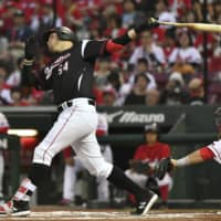 Chiba Lotte third baseman Brandon Laird connects on a home run during the sixth inning on Wednesday night at Mazda Stadium in Hiroshima. The Marines beat the Carp 6-3.