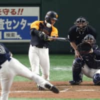 The Giants' Yoshihiro Maru whacks a two-run triple in the eighth inning against the Buffaloes on Thursday at Tokyo Dome. Yomiuri beat Orix 4-2.