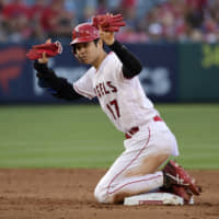 Los Angeles designated hitter Shohei Ohtani calls for time after stealing second base against Cincinnati in the sixth inning on Wednesday.