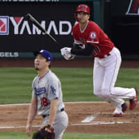 The Angels' Shohei Ohtani watches his home run off Dodgers pitcher Kenta Maeda during the first inning on Tuesday in Anaheim, California.