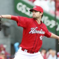 Hiroshima's Kris Johnson throws against the Eagles on Sunday at Rakuten Seimei Park Miyagi.
