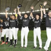 SoftBank players celebrate their interleague championship-clinching win over the Giants on Sunday at Tokyo Dome.