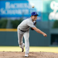 Los Angeles starter Kenta Maeda pitches against Colorado in the first inning on Monday night.
