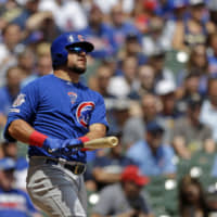 The Cubs' Kyle Schwarber watches his grand slam against the Brewers during the second inning on Sunday in Milwaukee.