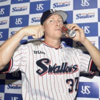 Tokyo Yakult Swallows All-Star pitcher Scott McGough poses for photographs after a game on Wednesday.