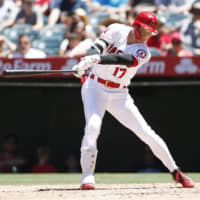 Angels designated hitter Shohei Ohtani hits his first of two home runs against Oakland on Sunday in Anaheim, California.