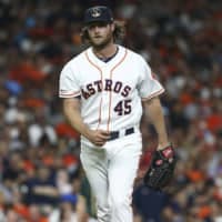 Houston starter Gerrit Cole reacts after a strikeout against Oakland in the sixth inning on Monday night.