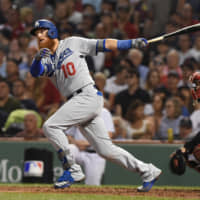 Dodgers third baseman Justin Turner hits an RBI double against the Red Sox on Saturday at Fenway Park.