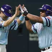 The Hawks' Alfredo Despaigne (right) is congratulated by Seiichi Uchikawa after his three-run homer against the Buffaloes during the third inning on Sunday at Yafuoku Dome in Fukuoka.