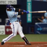Yurisbel Gracial of the SoftBank Hawks drives in a game-tying run with a sacrifice fly in the third inning against the Seibu Lions on Monday at Kyocera Dome. The Hawks won 2-1.