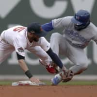 Red Sox second baseman Dustin Pedroia fails to tag out the Blue Jays' Teoscar Hernandez on a stolen-base attempt in April.