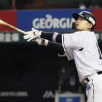 The Lions' Tomoya Mori watches the flight of his two-run home run in the seventh inning against the Hawks on Friday night at MetLife Dome. Seibu beat Fukuoka SoftBank 4-2.