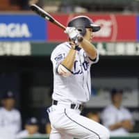 The Lions' Shogo Akiyama hits a bases-loaded single in the fifth inning against the Fighters on Tuesday night at MetLife Dome. Seibu defeated Hokkaido Nippon Ham 4-2.