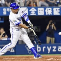 The BayStars' Jose Lopez strokes a two-run double in the sixth inning against the Giants on Friday night at Yokohama Stadium. Yokohama beat Yomiuri 4-2.