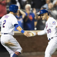 The Mets' Michael Conforto (right) celebrates with Joe Panik after hitting a two-run home run against the Indians during the sixth inning on Tuesday in New York.