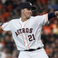 Astros starter Zack Greinke pitches against the Rockies during the first inning on Tuesday in Houston.