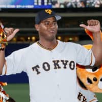 Yomiuri starter Cristopher Mercedes celebrates after helping the team snap a six-game losing streak on Wednesday night against Chunichi at Nagoya Dome.