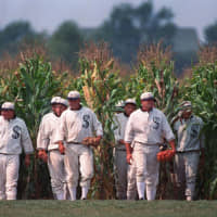 In this June 1997 file photo, people portraying ghost players emerge from a cornfield as they reenact a scene from the movie "Field of Dreams" at the movie site in Dyersville, Iowa. The Chicago White Sox and New York Yankees will play a game at the site where the movie was filmed next August.