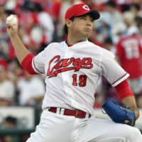 Carp hurler Yusuke Nomura pitches against the BayStars on Thursday night at Mazda Stadium. Hiroshima defeated Yokohama 4-1.