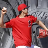 The Angels' Shohei Ohtani pitches during a bullpen session on Saturday in Anaheim, California.