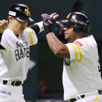 SoftBank's Alfredo Despaigne is greeted by teammate Seiichi Uchikawa at home plate after his two-run home run in the first inning on Sunday against the Fighters at Yafuoku Dome.