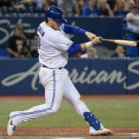 Toronto's Danny Jansen blasts a home run against Texas in the eighth inning on Monday.