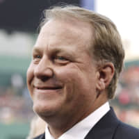Former Red Sox pitcher Curt Schilling smiles after being introduced at Fenway Park in August 2012. Schilling has expressed interest in running for Congress in Arizona.