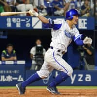 The BayStars' Takayuki Kajitani delivers a go-ahead single in the seventh inning against the Swallows on Thursday night at Yokohama Stadium. Yokohama beat Tokyo Yakult 4-2.