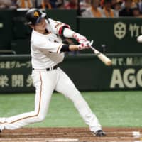 Giants captain Hayato Sakamoto slugs a solo home run in the first inning against the Tigers on Saturday afternoon at Tokyo Dome. Yomiuri topped Hanshin 4-2.