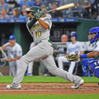 The Athletics' Marcus Semien triples in three runs in the second inning against the Royals at Kauffman Stadium on Monday.