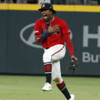Center fielder Ronald Acuna Jr. reacts after the Braves beat the Giants on Friday to clinch the NL East title in Atlanta.