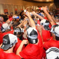 The Nationals celebrate in their clubhouse after clinching a playoff berth on Tuesday in Washington.