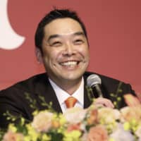 Giants catcher Shinnosuke Abe smiles during a news conference to announce his retirement on Wednesday.