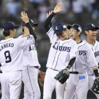 Lions players celebrate after their win over the Hawks on Wednesday in Tokorozawa, Saitama Prefecture.