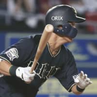 The Buffaloes' Hayato Nishiura hits an RBI single in the second inning against the Marines on Monday at Zozo Marine Stadium. The game ended in a 2-2 tie.
