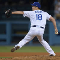 Los Angeles reliever Kenta Maeda pitches against Colorado in the sixth inning on Monday night.
