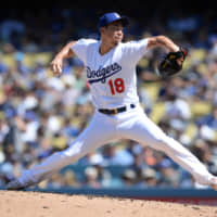 Dodgers reliever Kenta Maeda pitches against the Giants during the third inning on Sunday in Los Angeles. Maeda struck out six in the victory.