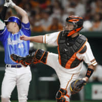 Giants catcher Shinnosuke Abe throws to second during the first inning on Friday night at Tokyo Dome.