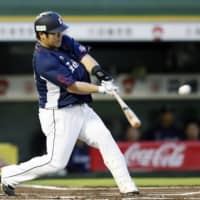 The Lions' Takeya Nakamura belts a first-inning homer against the Buffaloes in Tuesday's game at Hotto Motto Field. Seibu defeated Orix 5-1.
