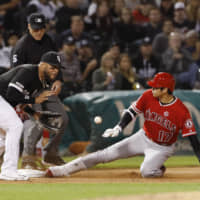 Los Angeles Angels designated hitter Shohei Ohtani slides into third base with a triple in the seventh inning on Friday night.