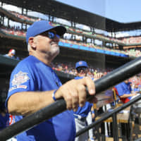 Cubs manager Joe Maddon looks out from the dugout before Sunday's game against the Cardinals in St. Louis. Maddon will not be returning to the team next season.