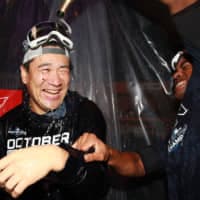 The Yankees' Luis Severino pours champagne over teammate Masahiro Tanaka as they celebrate clinching the American League East after defeating the Angels on Thursday in New York.