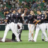 Lotte players celebrate their win over the Hawks on Monday at Yafuoku Dome.